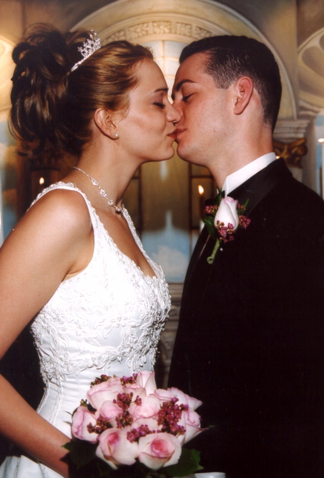 A bride and groom share a kiss inside the Princess Wedding Chapel